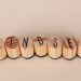 Wooden letter stamps spelling 'Mindset' on a simple beige background, conveying focus and positive thinking.